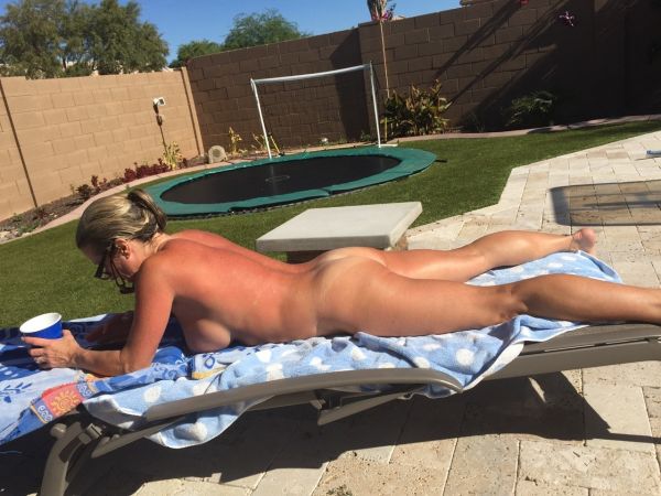 neighbor tanning in back yard