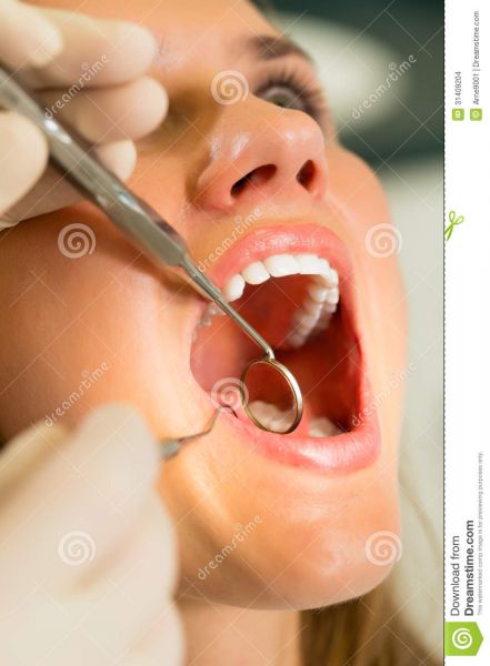 female dentist putting on gloves