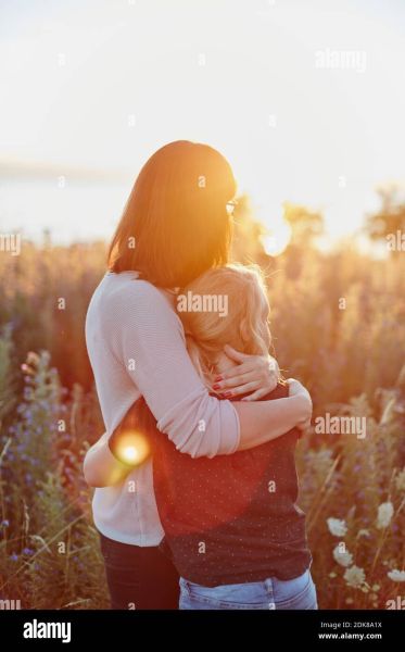 mother hugging teenage daughter sitting on a bench pics