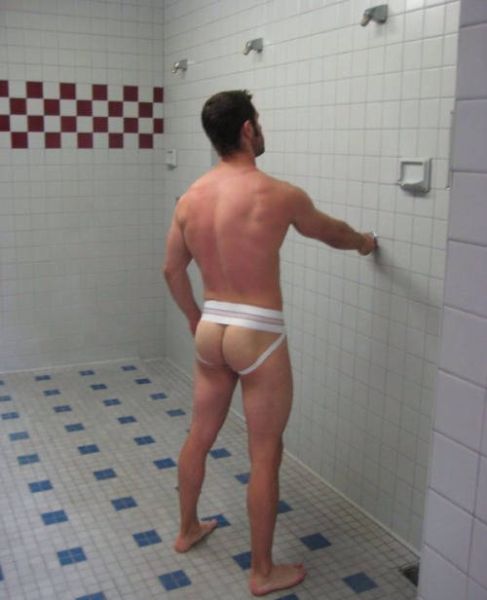 male hockey player wearing can in locker room