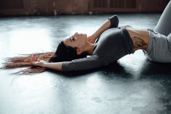 woman in dress lying on sofa